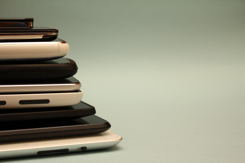A stack of nine different smartphones