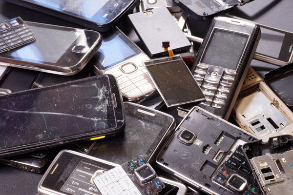 A pile of e-waste consisting of different mobile devices