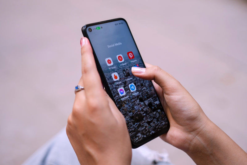 A women's hands holding an Android phone