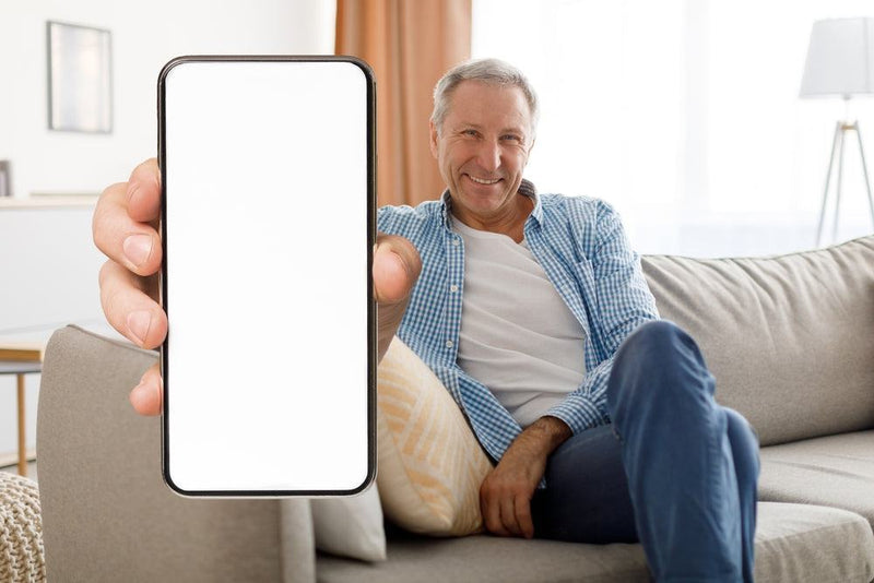 senior man holding out a smartphone 